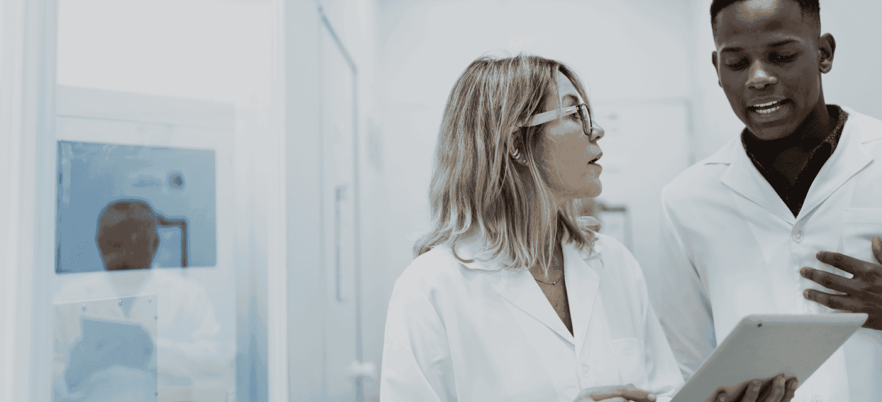 Homepage image - A researcher talking to her colleague, while looking at an iPad