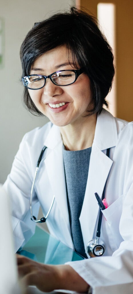 Female doctor feeling happy while reading